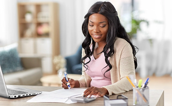young woman with laptop and calculator